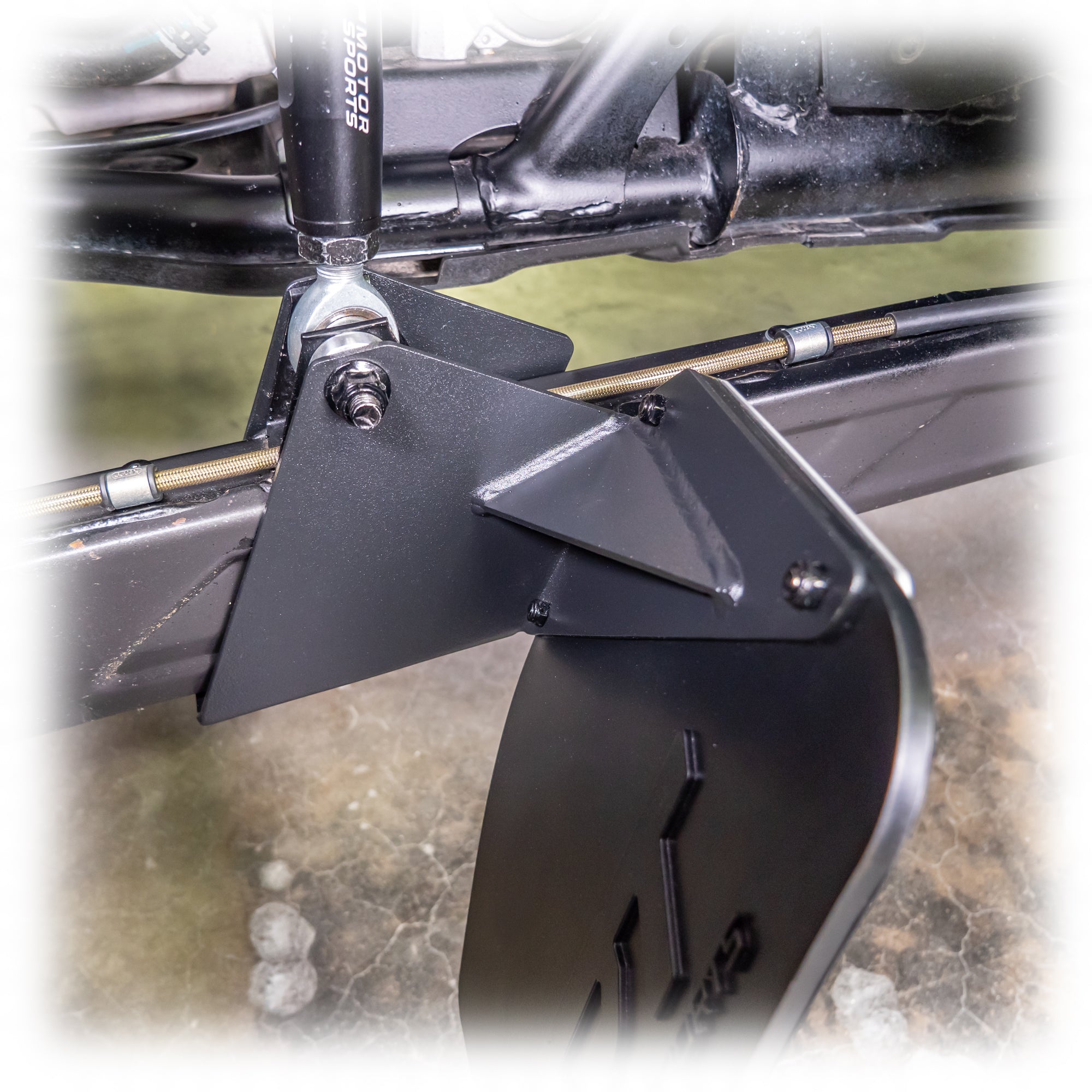 Bolt-on rock guard mount on trailing arm of Polaris RZR Pro XP