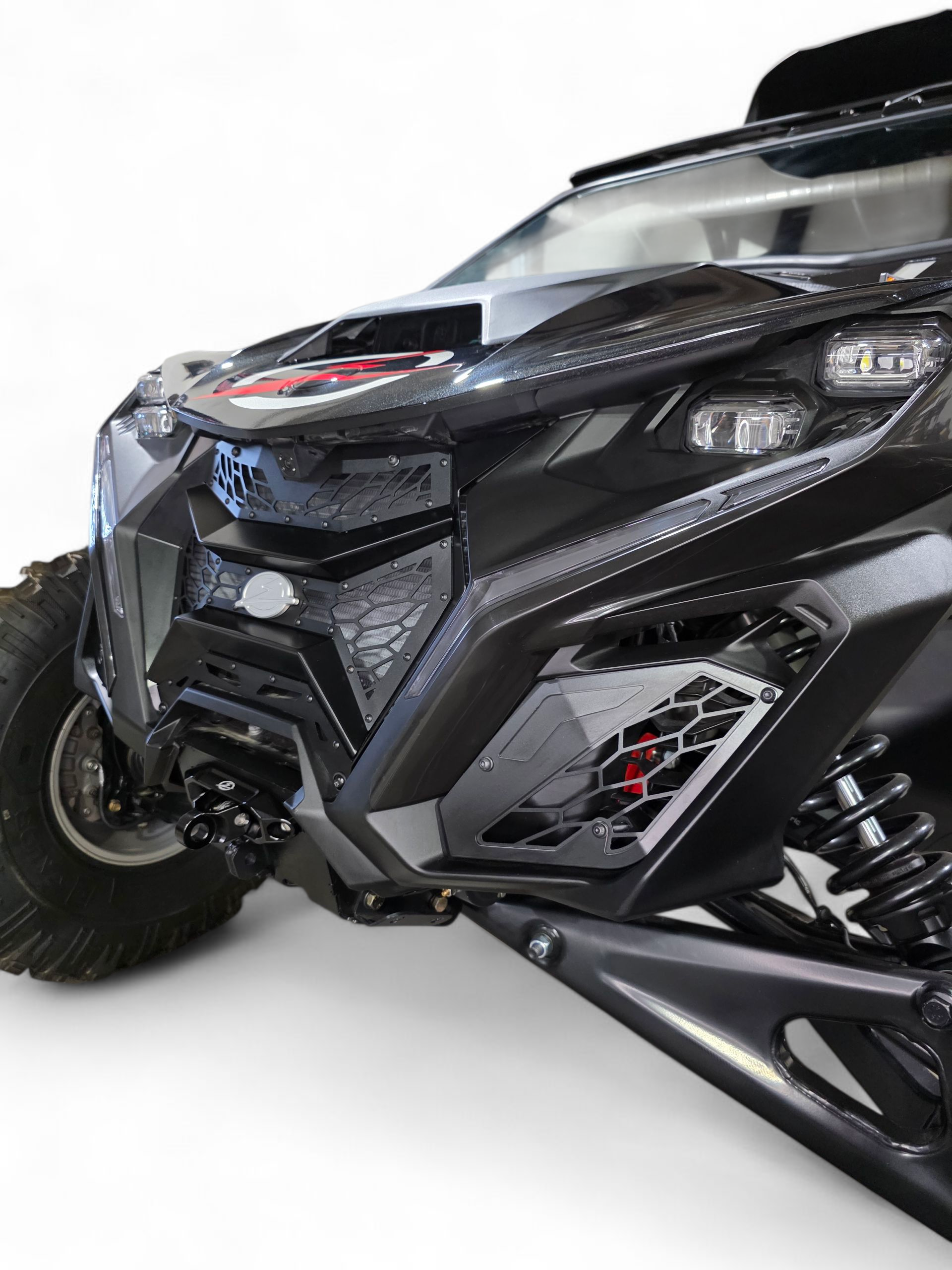 Side angle detail of Volt 3-Piece Grille installed on 2024 Can-Am Maverick R
    showing how grille follows natural body contour lines of front fascia