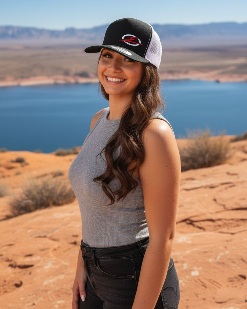 Close-up of woman model wearing the EOD trucker hat showing the front logo and mesh back detail