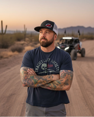 Man wearing the EOD Two-Tone Trucker Hat outdoors next to a UTV on the trail