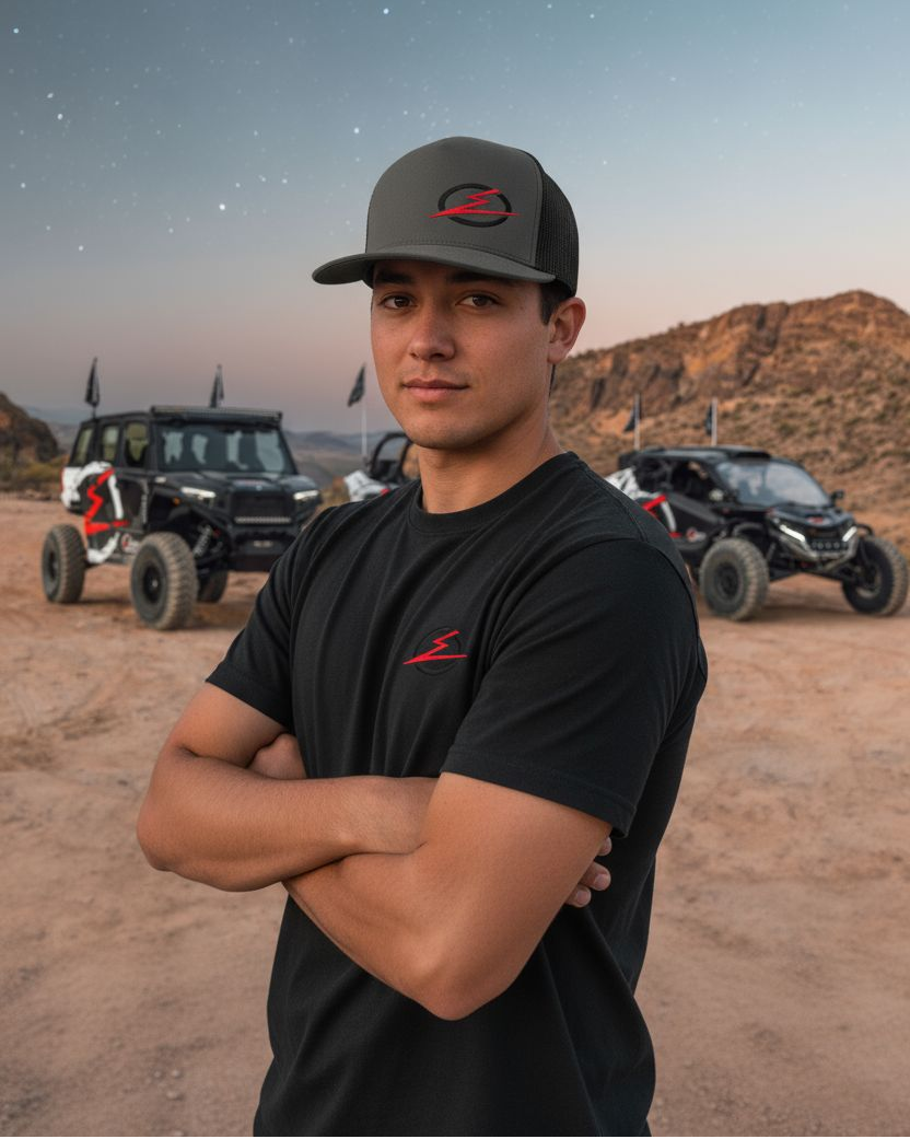 Close-up of man model wearing the EOD charcoal trucker hat showing the front logo and mesh back detail