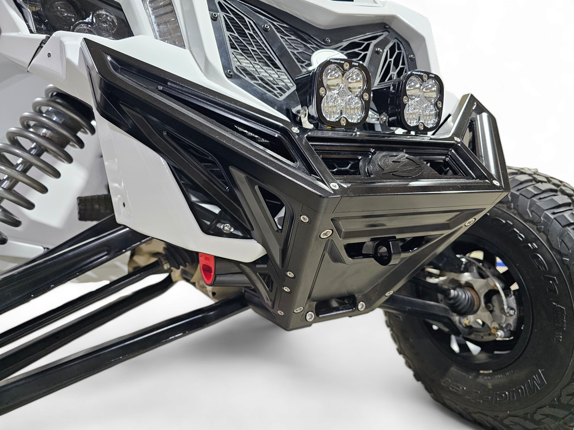 Full machine front view of Can-Am Maverick X3 fitted with black anodized billet winch bumper and aggressive blacked-out stance

